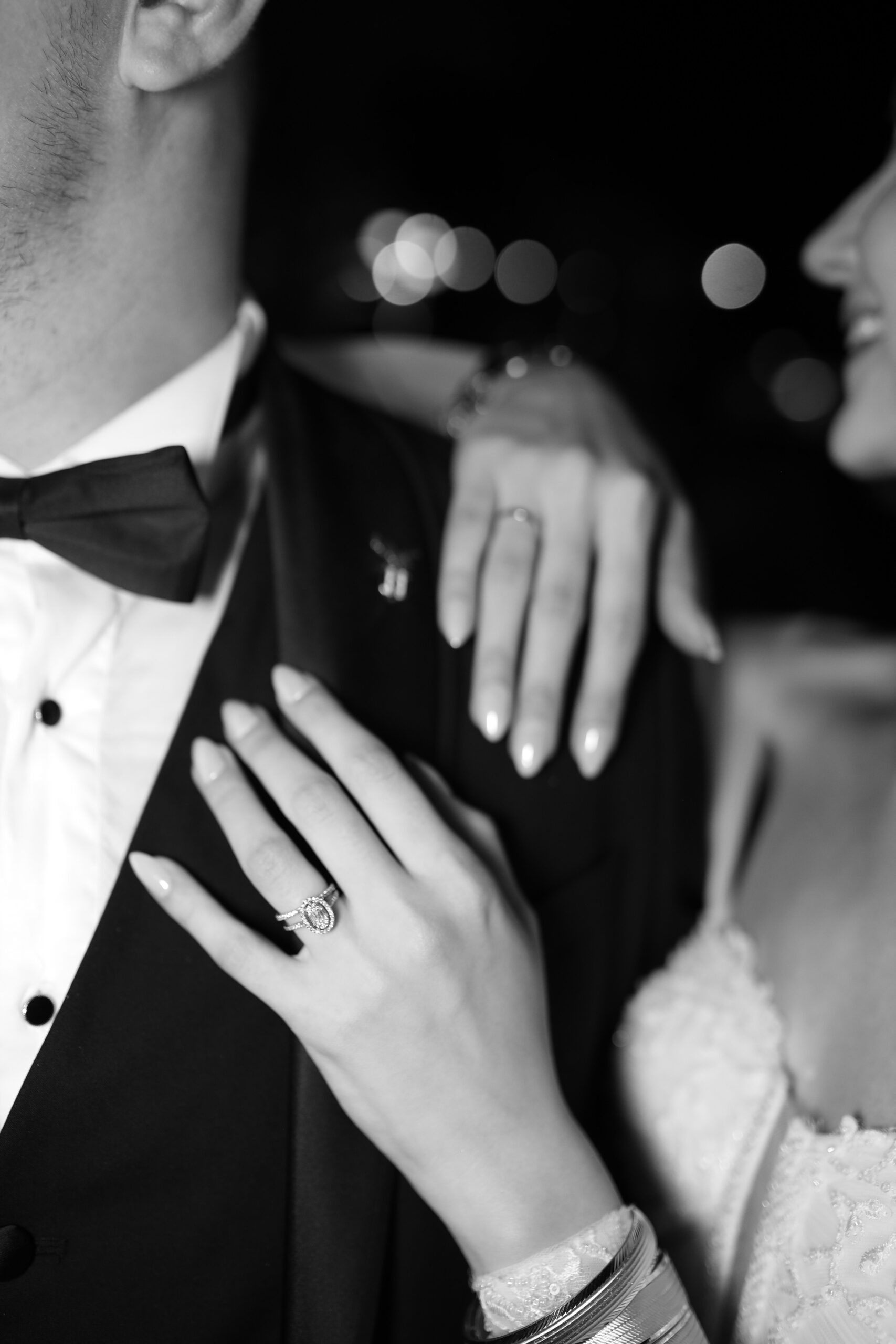 Close-up of a couple embracing on their wedding day, in black and white.